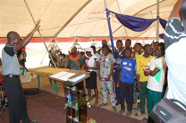 Students responding to an altar call under the tent