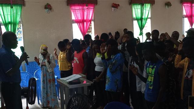 Young people praying together during an altar call