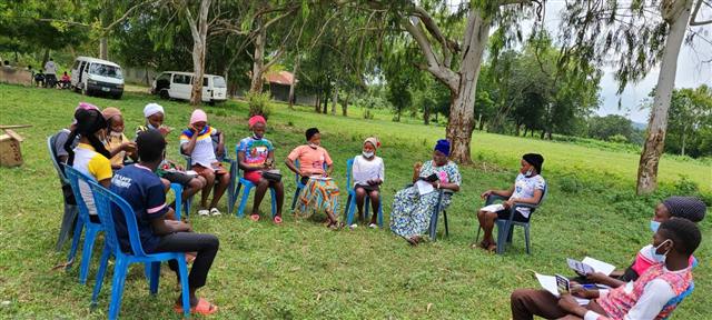 Students seated on chairs outdoors for a Bible study group